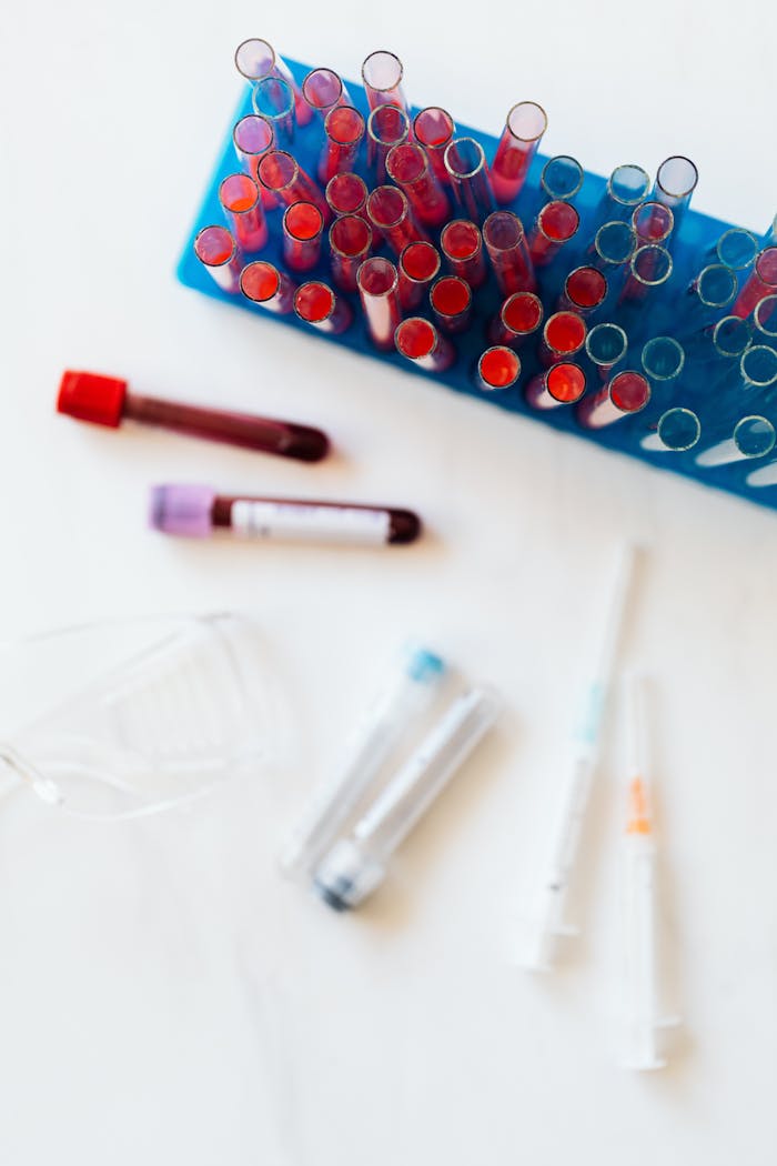 get-in-touch Vibrant laboratory test tubes and medical equipment on white background.