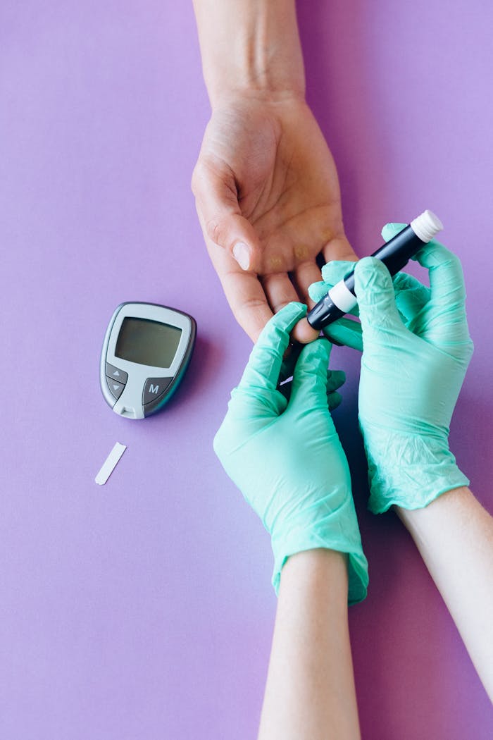 A healthcare worker uses a glucose meter to check a patient's blood sugar level.